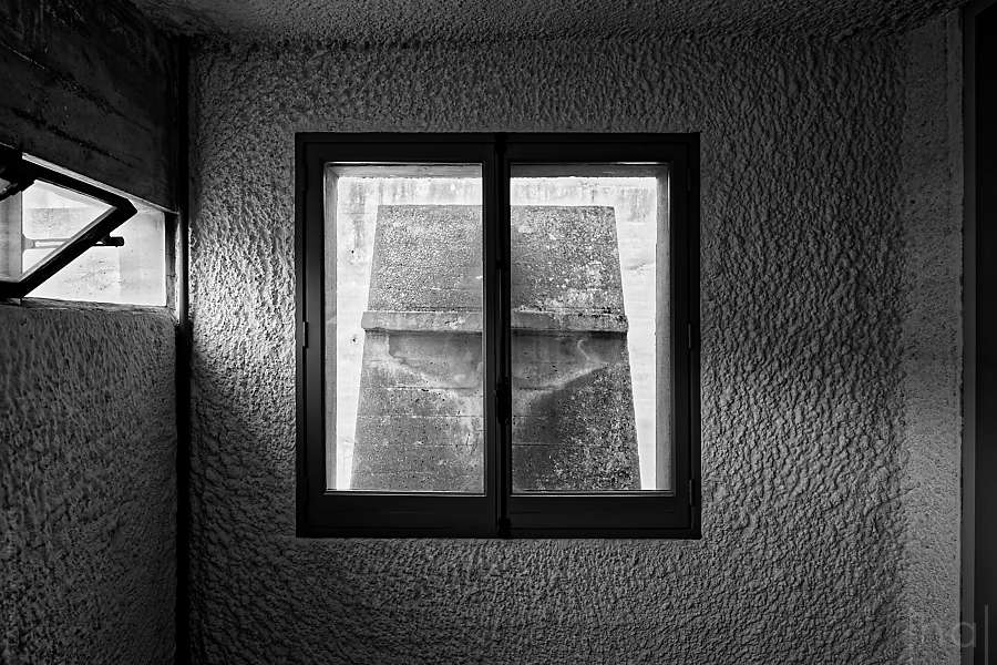 Window obscured by a concrete flower
